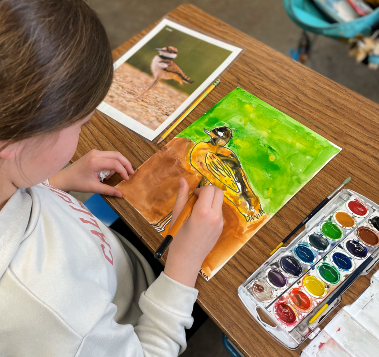 Harney County youth painting a killdeer during the 2024 Artist in Residence Prog